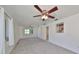 Spacious living room with carpet, fan, and large windows for ample natural light at 3908 W Wallace Ave, Tampa, FL 33611
