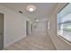 Living Room featuring neutral walls, gray tile floors, and natural lighting at 3908 W Wallace Ave, Tampa, FL 33611