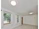 Bright, airy living room with large windows, updated lighting, and sleek tile flooring at 3908 W Wallace Ave, Tampa, FL 33611