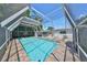 Outdoor pool with screened enclosure, patio, and backyard creating a serene atmosphere at 3908 W Wallace Ave, Tampa, FL 33611
