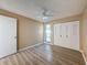 Comfortable bedroom featuring wood-look flooring, closet space, and a window for natural light at 7702 Ivory Ter, New Port Richey, FL 34655