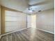 Spacious bedroom featuring wood-look flooring and ensuite bath at 7702 Ivory Ter, New Port Richey, FL 34655