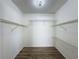 Walk-in closet with wood-look flooring and multiple levels of wire shelving at 7702 Ivory Ter, New Port Richey, FL 34655