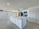 Open concept kitchen featuring a large island with seating, stainless steel appliances, and ample cabinet space at 7702 Ivory Ter, New Port Richey, FL 34655