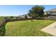 Grass backyard with firepit and wooden fence at 5707 Butterfield St, Riverview, FL 33578