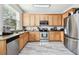 Bright kitchen with stainless steel appliances and granite countertops at 5707 Butterfield St, Riverview, FL 33578