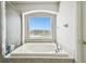 Relaxing bathroom tub with window and view at 5707 Butterfield St, Riverview, FL 33578