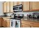 Modern kitchen with stainless steel appliances and granite countertops at 5707 Butterfield St, Riverview, FL 33578