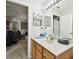 Bathroom with wood vanity, marble countertop, and mirror at 5707 Butterfield St, Riverview, FL 33578