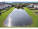 Aerial view of a pond surrounded by homes at 5707 Butterfield St, Riverview, FL 33578