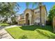 Two-story house with tan exterior, two-car garage and nicely landscaped lawn at 5707 Butterfield St, Riverview, FL 33578