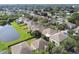 Aerial view of a residential neighborhood with houses and a lake at 5707 Butterfield St, Riverview, FL 33578