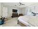 Spacious bedroom with large TV, comfy chair, and treadmill at 5707 Butterfield St, Riverview, FL 33578