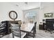 Dining room with a large wooden table, six chairs, and a stylish mirror at 5707 Butterfield St, Riverview, FL 33578
