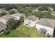 Aerial view of a home's backyard with patio, fire pit, and fence at 5707 Butterfield St, Riverview, FL 33578