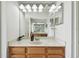 Bathroom with wood vanity, marble countertop, and large mirror at 5707 Butterfield St, Riverview, FL 33578