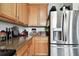 Kitchen corner with stainless steel refrigerator and granite countertop at 5707 Butterfield St, Riverview, FL 33578