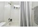 Clean bathroom with shower/tub combo and gray striped curtain at 5707 Butterfield St, Riverview, FL 33578
