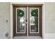 Double front doors with glass panels and wreaths at 5707 Butterfield St, Riverview, FL 33578
