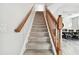 Carpeted staircase with wooden railing leading to the second floor at 5707 Butterfield St, Riverview, FL 33578