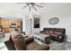 Living room with brown leather furniture and a view into the kitchen at 5707 Butterfield St, Riverview, FL 33578