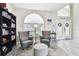 Bright and spacious entryway with two comfy armchairs, a bookcase, and an arched window at 5707 Butterfield St, Riverview, FL 33578