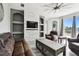 Living room with leather sofas, a coffee table, built-in shelving, and backyard access at 5707 Butterfield St, Riverview, FL 33578