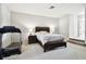 Bright bedroom with a queen-size bed and treadmill at 5707 Butterfield St, Riverview, FL 33578