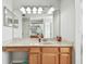 Clean bathroom with a single sink vanity and bright lighting at 5707 Butterfield St, Riverview, FL 33578
