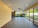 Bright screened patio featuring a ceiling fan and backyard access at 7702 Ivory Ter, New Port Richey, FL 34655