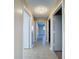 Clean hallway with tile flooring and access to bedrooms and other rooms at 7702 Ivory Ter, New Port Richey, FL 34655