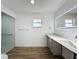 Updated bathroom with walk-in shower, modern vanity, and stylish flooring at 7702 Ivory Ter, New Port Richey, FL 34655