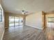 Living room with wood-look floors and sliding glass doors to a patio at 7702 Ivory Ter, New Port Richey, FL 34655