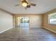 Living room with wood-look floors and sliding doors leading to the patio at 7702 Ivory Ter, New Port Richey, FL 34655