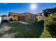 House's backyard with grassy area and screened patio at 7702 Ivory Ter, New Port Richey, FL 34655