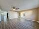 Spacious living area with wood-look floors and patio access at 7702 Ivory Ter, New Port Richey, FL 34655