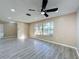 Bright living room featuring wood-look floors and sliding glass doors leading to the patio at 7702 Ivory Ter, New Port Richey, FL 34655
