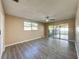 Bright bedroom with wood-look floors and access to a patio at 7702 Ivory Ter, New Port Richey, FL 34655