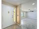 View of entryway and living room with wood-look flooring at 7702 Ivory Ter, New Port Richey, FL 34655