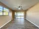 Spacious living room with wood-look floors and access to a patio at 7702 Ivory Ter, New Port Richey, FL 34655