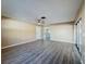 Living room with wood-look floors, view to kitchen and patio at 7702 Ivory Ter, New Port Richey, FL 34655