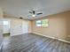Bright bedroom with wood-look floors and access to a bathroom and patio at 7702 Ivory Ter, New Port Richey, FL 34655