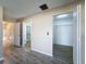 Spacious bedroom with wood-look floors and access to a large closet at 7702 Ivory Ter, New Port Richey, FL 34655