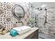 Modern bathroom with a floating sink, walk-in shower, and patterned tile at 1810 S Valrico Rd, Valrico, FL 33596