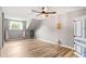 Charming bedroom with wood floors, sloped ceiling, and plenty of natural light at 1810 S Valrico Rd, Valrico, FL 33596
