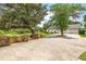 Long driveway with mature trees and landscaping at 1810 S Valrico Rd, Valrico, FL 33596