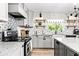 Stylish kitchen with gray cabinets, granite countertops and decorative backsplash at 1810 S Valrico Rd, Valrico, FL 33596