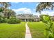 House with gray roof and lush green lawn at 1810 S Valrico Rd, Valrico, FL 33596