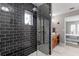 Large walk-in shower with dark tile and glass enclosure at 1810 S Valrico Rd, Valrico, FL 33596