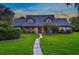 Two-story home with gray siding and a brick walkway at 1810 S Valrico Rd, Valrico, FL 33596